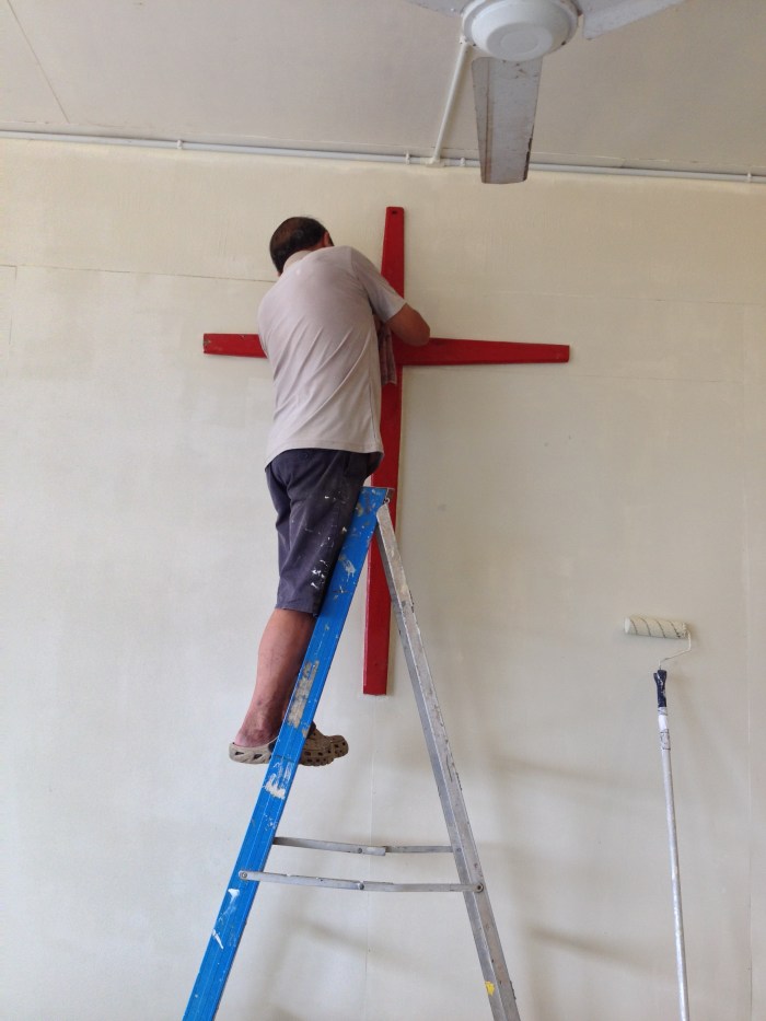 cleaning the cross in the multipurpose hall