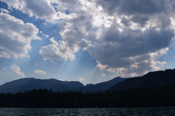 amazing rays of afternoon sun pierced through the clouds captured during a river cruise on Kanas Lake