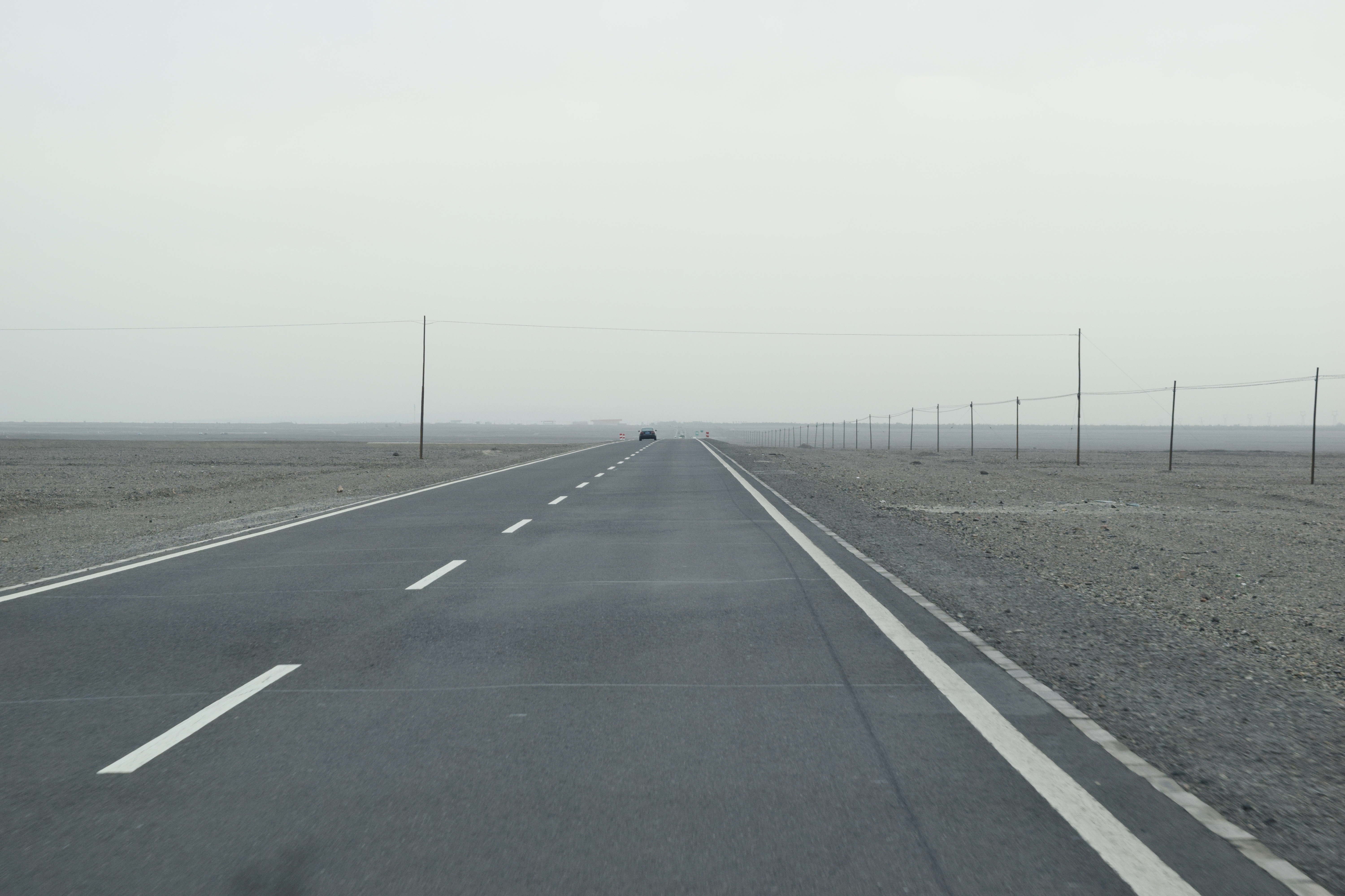 miles and miles of absolute nothingness on both sides of the road but Gobi (戈壁) sand! 寸草不生!