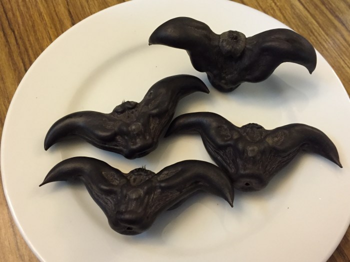 these funny looking "fruit" are 菱角 water chestnut/water caltrop and their texture is quite similar to the round Chinese water chestnuts but not as sweet or crunchy. they are sold in the market for Mid-autumn Festival 